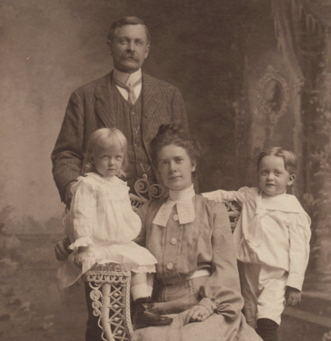 An unidentified 19th-century family poses with two children, potentially twins; the couple may have been part of the vanguard of the smaller families that characterized the 20th century. 