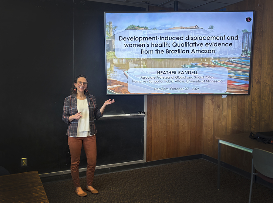 Heather Randell stands by a screen presenting in Wisconsin