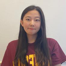 Portrait picture of Eunyoung Park in a UMN maroon shirt in front of a white wall 