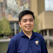 Portrait picture of Keo Pangan outside in a navy shirt